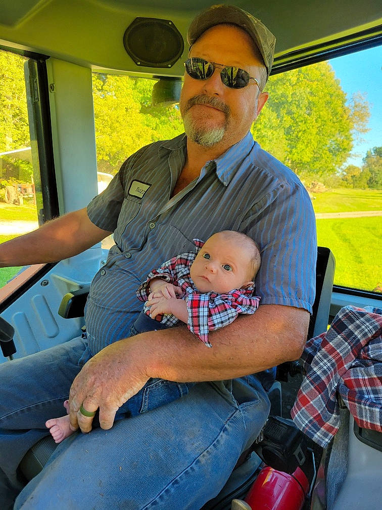 Levi joined the competition — help win amazing prizes! baby, baseball_cap, clothing, eyewear, fun, goggles, grass, hat, jeans, lap, leisure, motor_vehicle, people, person, recreation, sitting, smile, sunglasses, tartan, toddler