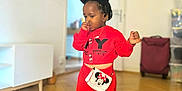 Aëla a rejoint le concours — aidez-le/la à gagner de superbes lots ! bag, black_shoes, casual_wear, child, cute, door, floor, furniture, hair_buns, home, indoors, minnie_mouse, person, purse, red_clothing, standing, thumb_sucking, toddler, wooden_floor, young_child
