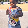 Aëla a rejoint le concours — aidez-le/la à gagner de superbes lots ! bracelet, building, child, cute, daylight, denim_overalls, drink, fashion, flags, minnie_mouse_purse, necklace, orange_sandals, outdoor, person, sidewalk, straw, sunny, toddler, trees, urban