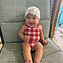 baby, child, smiling, sitting, swimsuit, turban, flower, chair, patterned_chair, barefoot, indoors, poolside, bracelet, cute, happy, portrait, infant, skin, headwear, plush