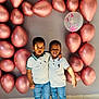 child, children, balloons, rose_gold, confetti, white_shirt, jeans, sneakers, indoor, floor, tile, wall, sunlight, shadow, smile, friendship, celebration, portrait, happy, together