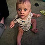 Haydn joined the competition — help win amazing prizes! baby, child, infant, onesie, carpet, floor, indoor, blue_eyes, sitting, reaching, toy, clothing, person, cute, curious, home, carpeted_floor, foot, hand, expression