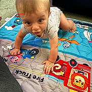 Haydn joined the competition — help win amazing prizes! baby, child, crawling, play_mat, fire_truck, cartoon, animal, indoor, carpet, clothing, hand, foot, person, face, head, toy, colorful, floor, cute, infant