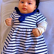 Sofia joined the competition — help win amazing prizes! baby, infant, child, curly_hair, striped_dress, navy_blue, white_clothing, lying_down, bed, soft_fabric, cute, small_fists, portrait, indoors, calm_expression, young_child, closeup, person, sleepwear, adorable