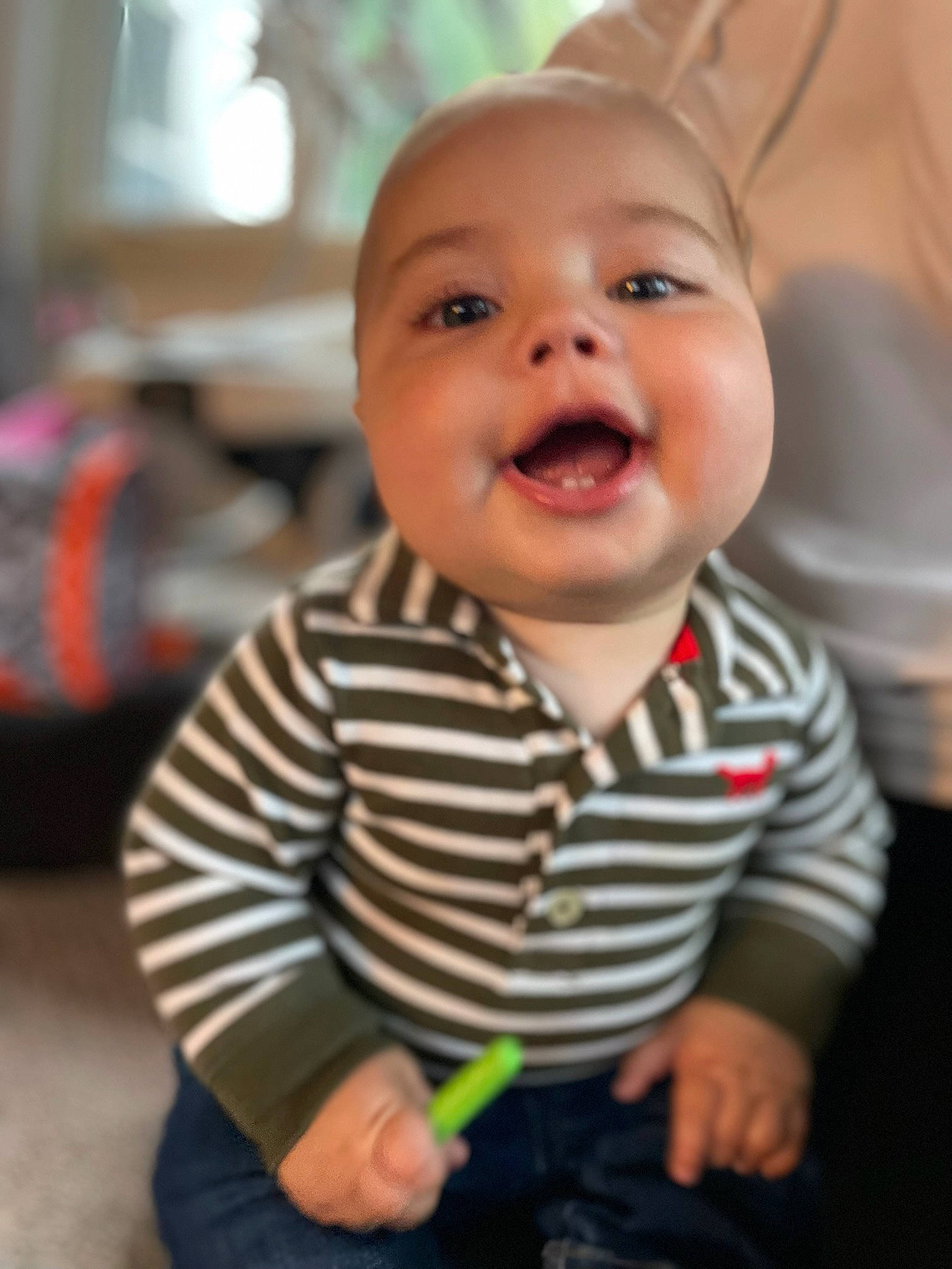 Lewis is registered to the contest to win money with this photo: baby, baby_laughing, baby_toddler_clothing, cheek, child, chin, eye, finger, flooring, gesture, happy, head, iris, mouth, nose, person, skin, sleeve, smile, thumb