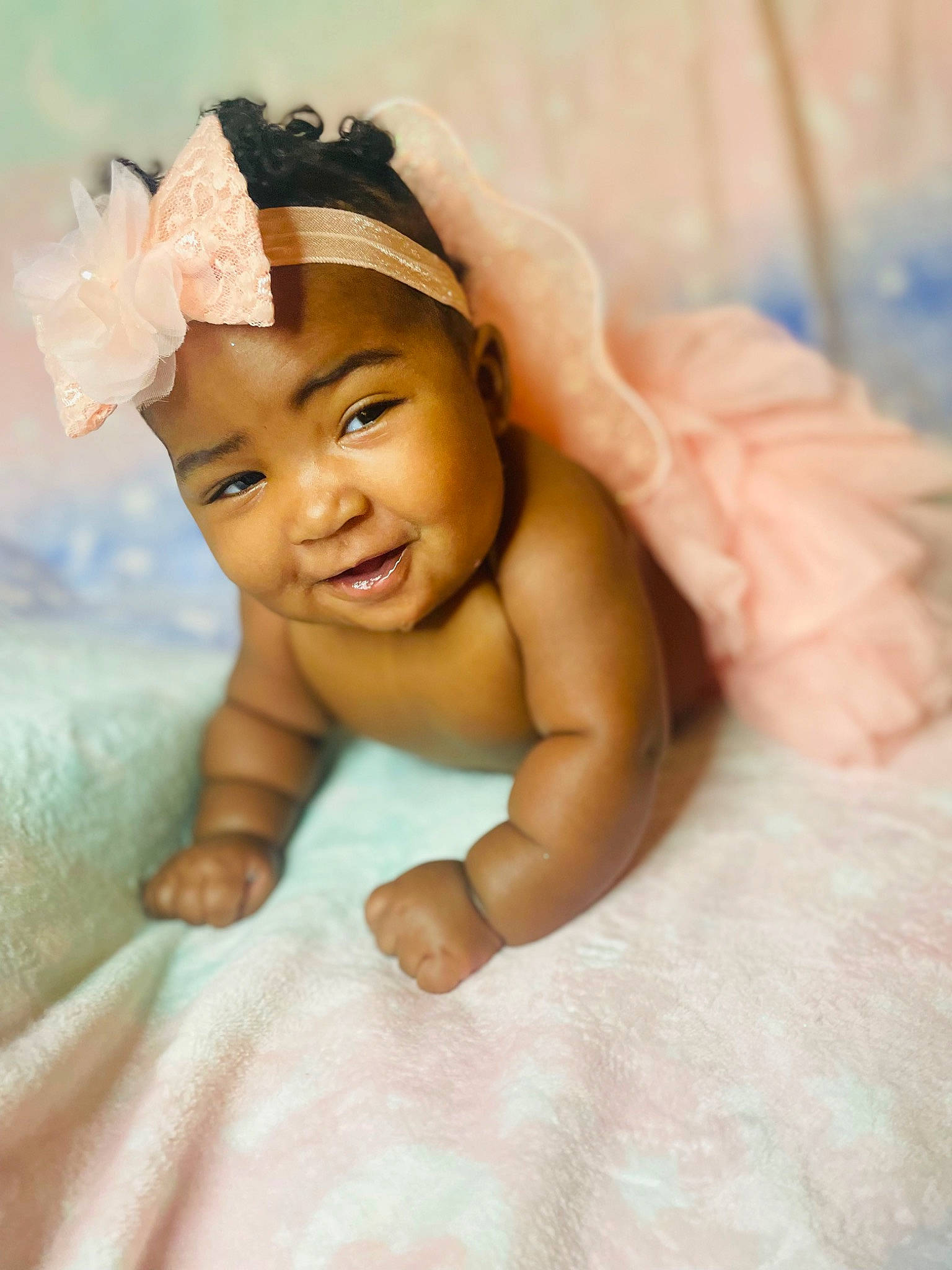 Tacara Mccray is registered to the contest to win money with this photo: baby, baby_toddler_clothing, bathing, cap, child, close_up, comfort, fashion_accessory, finger, flooring, fun, happy, headgear, headpiece, headwear, linens, person, room, skin, smile