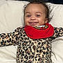 Cyonni is registered to the contest to win money with this photo: baby, smiling, leopard_print, onesie, red_bib, pillow, infant, cute, happy, face, clothing, lying_down, child, indoors, person, head, baby_garment, expression, joyful, young_child