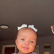 Cyonni joined the competition — help win amazing prizes! baby, child, smiling, indoor, girl, bow, hair_accessory, pink_shirt, face, portrait, cute, blue_eyes, head, clothing, decor, mirror, wall, light, person, toddler