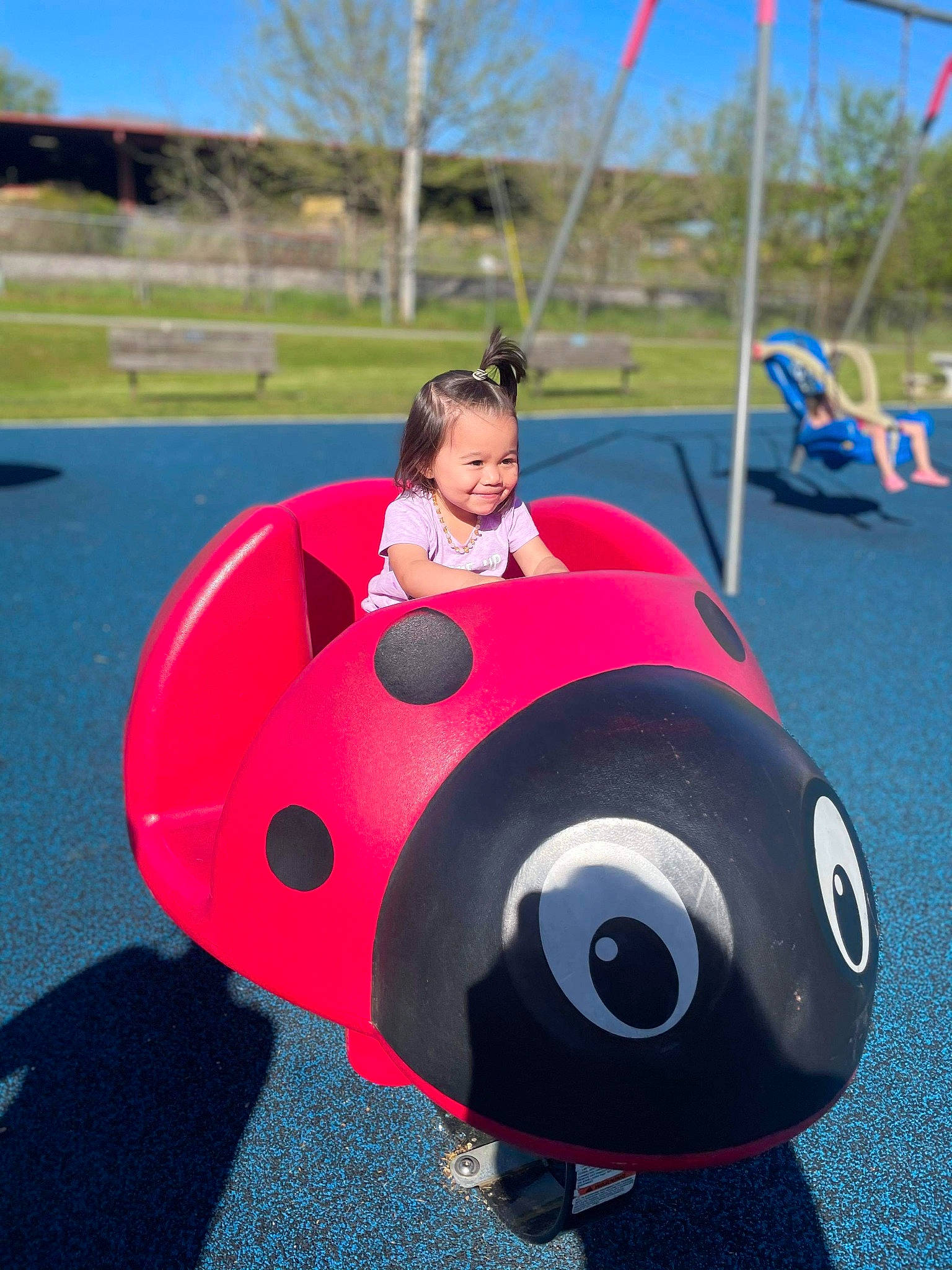 Danielle is registered to the contest to win money with this photo: auto_part, automotive_design, automotive_exterior, automotive_tire, automotive_wheel_system, bumper, eye, face, fun, joy, leisure, motor_vehicle, person, playground, recreation, rim, sky, tire, toddler, tree