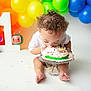 Zaylin joined the competition — help win amazing prizes! toddler, cake, birthday, celebration, balloons, colorful, curly_hair, messy, toy, number_one, party, child, happy, smiling, white_background, plate, feet, fun, cute, indoors