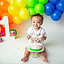 toddler, cake, birthday, smiling, balloons, colorful, celebration, first_birthday, cream, happy, child, party, decorations, white_background, cute, food, sitting, toy, face_paint, festive