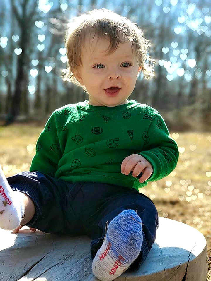 Shawn Jr is registered to the contest to win money with this photo: baby, cheek, child, grass, green, person, play, sitting, sleeve, smile, toddler, tree