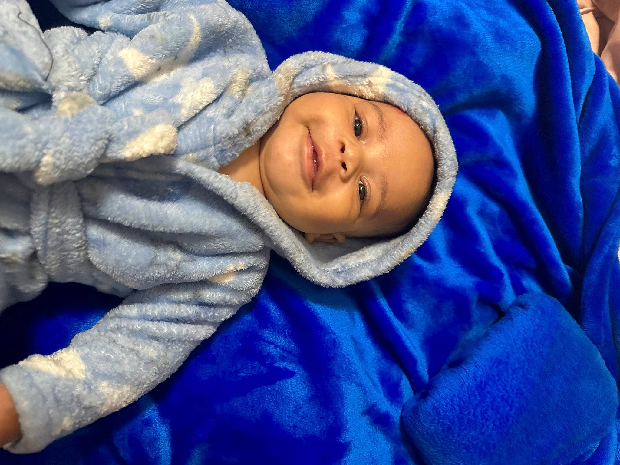 Ezrah joined the competition — help win amazing prizes! baby, baby_toddler_clothing, blue, cheek, child, comfort, electric_blue, eye, face, fun, grass, happy, joy, linens, nose, outerwear, person, purple, smile, toddler