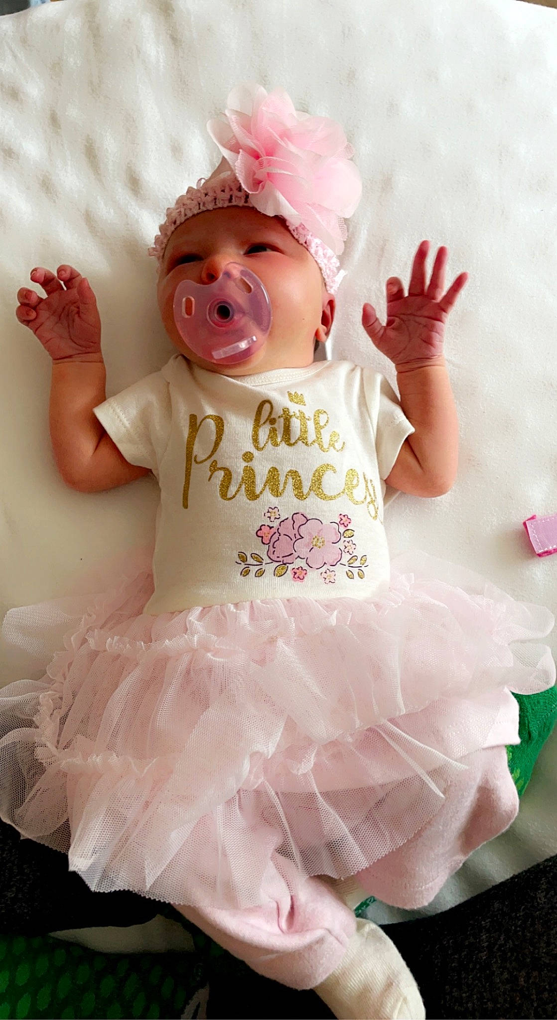 Eleanor is registered to the contest to win money with this photo: baby, baby_toddler_clothing, ballet_tutu, child, embellishment, event, fashion_accessory, happy, hat, headband, headgear, headpiece, magenta, peach, person, pink, ruffle, sleeve, textile, toddler