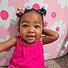 toddler, child, baby, girl, smiling, happy, portrait, pink_dress, hair_bow, pigtails, flower_pattern, background, carpet, indoor, cute, playful, person, face, skin, expression