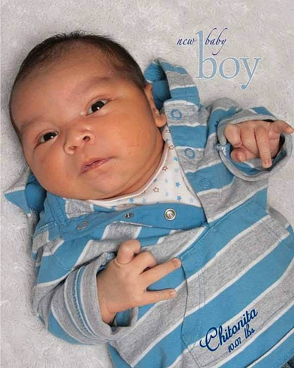 Izac is registered to the contest to win money with this photo: azure, baby, baby_products, baby_toddler_clothing, cheek, child, comfort, finger, gesture, hand, handwriting, happy, linens, pattern, person, pink, skin, sleeve, textile, thumb