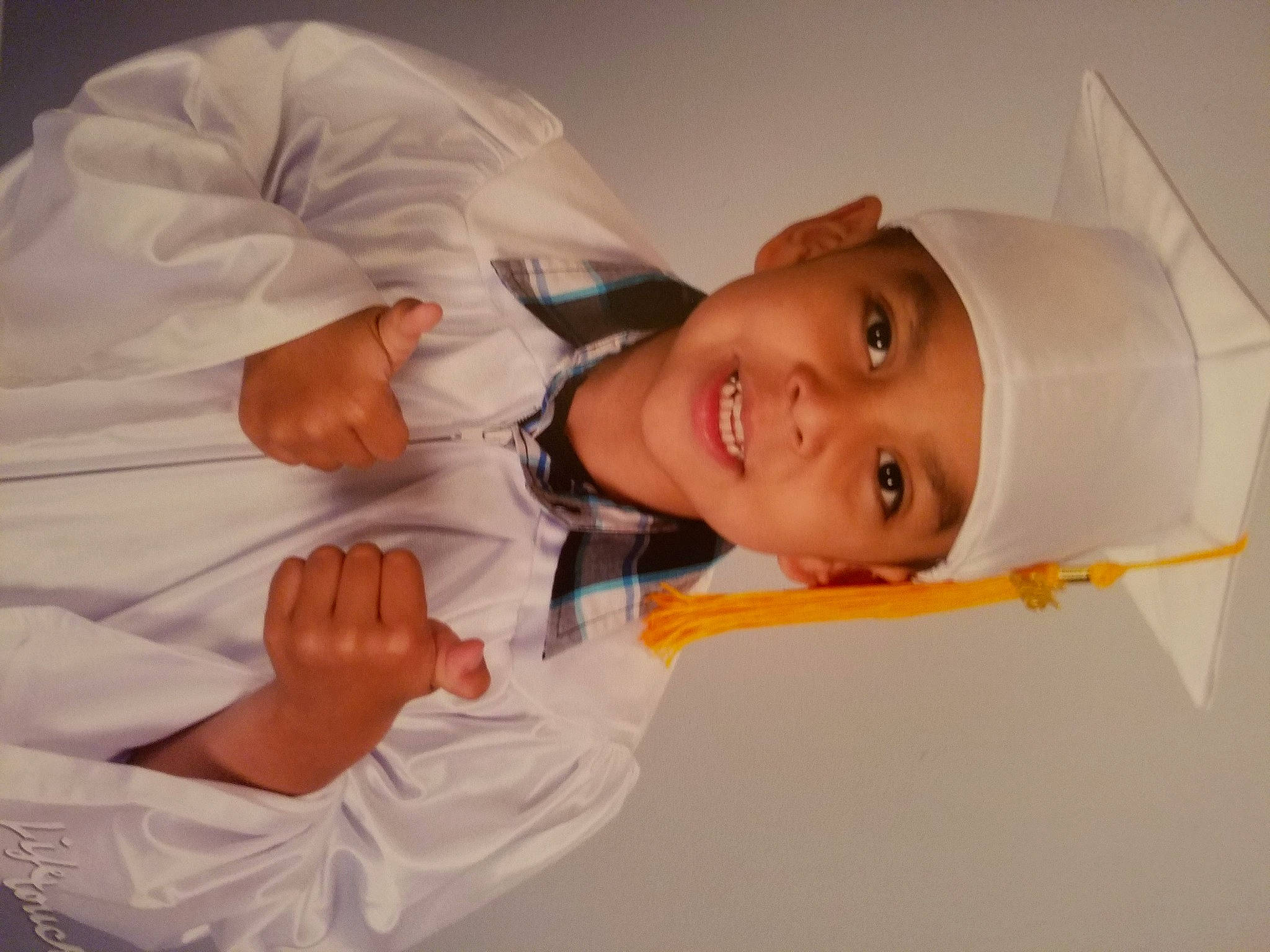 Izac is registered to the contest to win money with this photo: baby, child, dress_shirt, event, fun, gesture, happy, headwear, human_body, joy, person, room, sleeve, smile, toddler, uniform