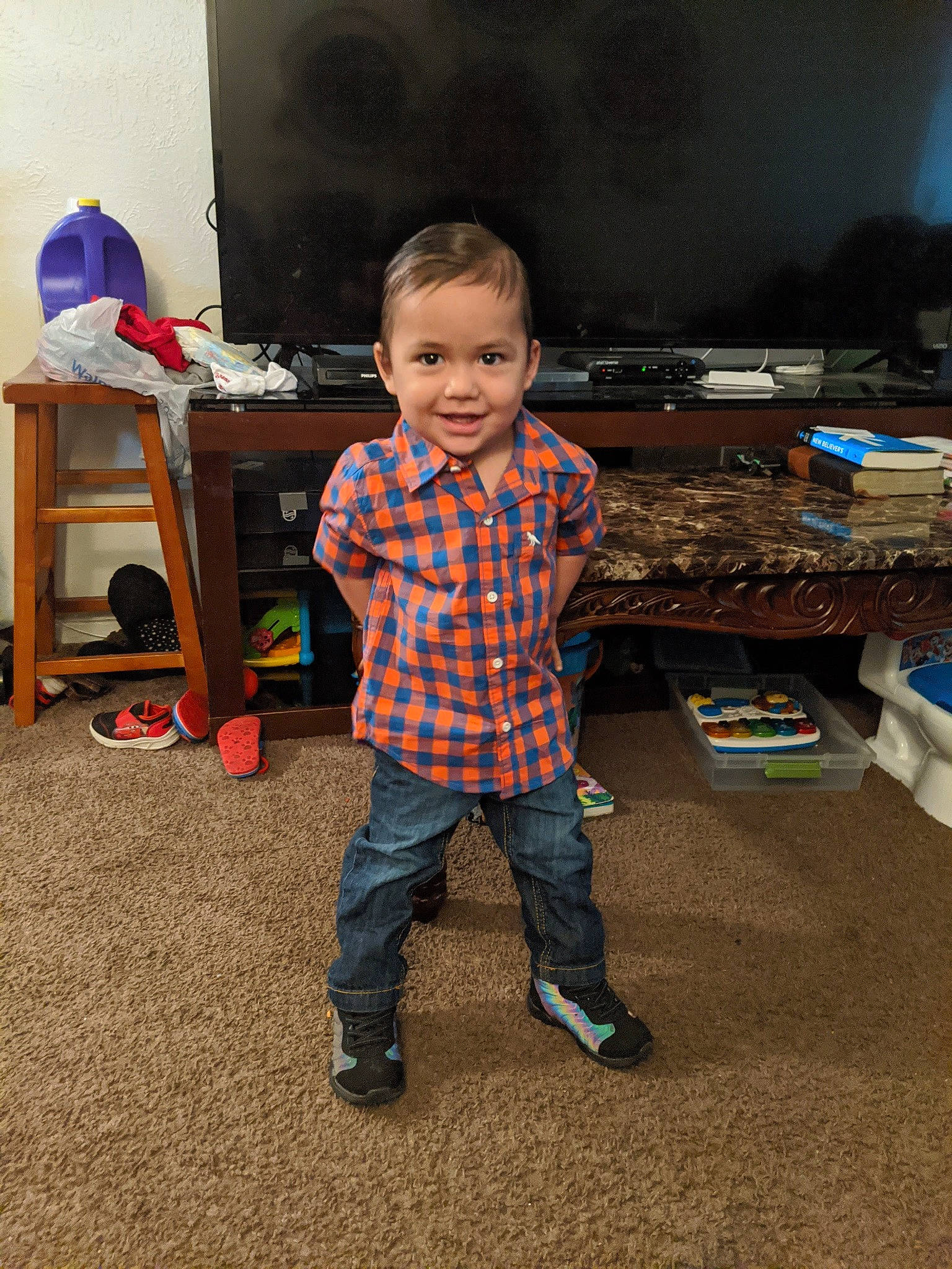 Jason is registered to the contest to win money with this photo: baby, box, child, desk, floor, flooring, fun, happy, joy, pattern, person, plaid, play, room, sitting, smile, standing, t_shirt, table, toddler