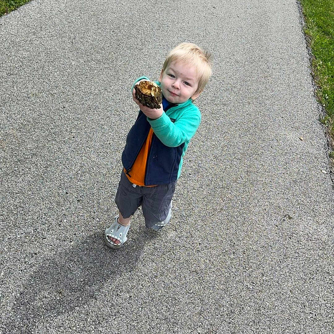 Asher joined the competition — help win amazing prizes! baseball, baseballglove, city, clothing, coat, face, glove, grass, head, jacket, pants, path, person, photography, plant, portrait, road, street, urban, walking