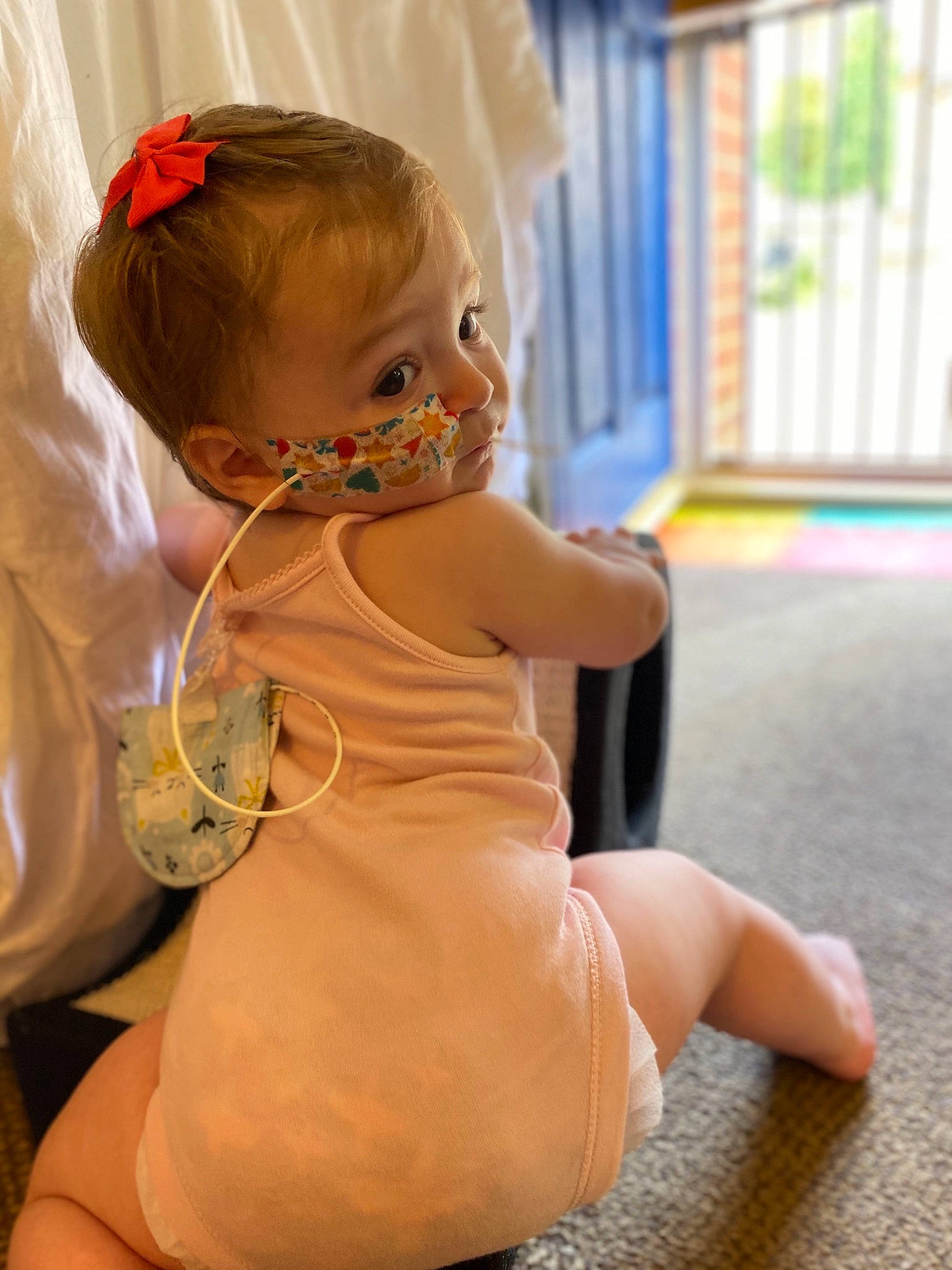 Lilly-ann is registered to the contest to win money with this photo: arm, baby, blond, cheek, child, dress, flooring, joint, leg, person, shoulder, sitting, skin, toddler, yellow