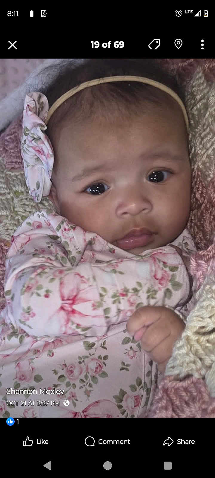 Myra is registered to the contest to win money with this photo: baby, infant, face, headband, floral_pattern, blanket, knitted, cute, child, portrait, clothing, hand, skin, young, indoors, expression, person, closeup, soft, warm