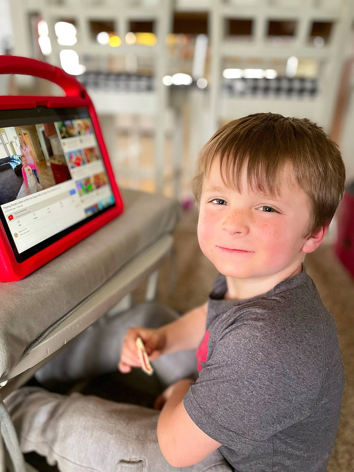 Colton is registered to the contest to win money with this photo: automotive_design, child, communication_device, display_device, fun, gadget, happy, job, joy, leisure, machine, multimedia, passenger, person, product, public_transport, sitting, sleeve, smile, t_shirt