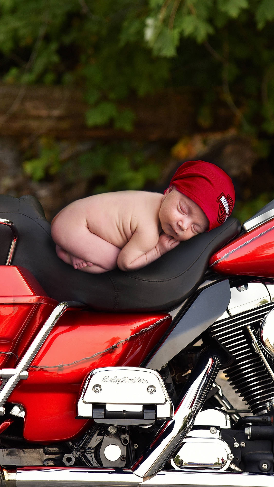 Brooklynn is registered to the contest to win money with this photo: automotive_design, baby_products, fender, headwear, lap, motorcycle, motorcycle_accessories, person, product, red