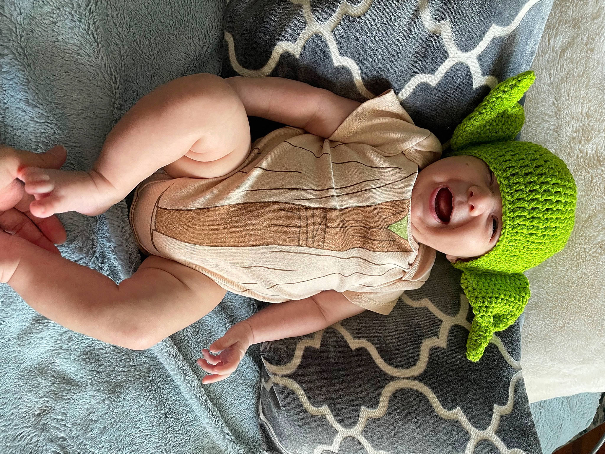 Asher is registered to the contest to win money with this photo: abdomen, arm, baby, baby_products, baby_toddler_clothing, chest, comfort, eye, finger, foot, hand, headwear, human_body, human_leg, leg, linens, pattern, person, skin, stomach