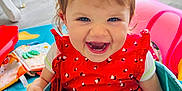 Lana a rejoint le concours — aidez-le/la à gagner de superbes lots ! toddler, child, smiling, red_dress, indoor, toys, play_mat, happy, laughing, fabric_container, short_hair, baby, floor, colorful, cute, person, playroom, fun, bright, casual