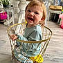 Lana participe au concours pour gagner de l'argent avec cette photo : toddler, child, smiling, sitting, basket, clothing, indoor, floor, toy, furniture, happy, hair, person, plush, decor, home, light, cozy, cute, playful