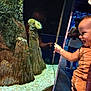Odin is registered to the contest to win money with this photo: animal, aquarium, aquatic, baby, bodypart, clothing, face, finger, fish, footwear, hand, head, invertebrate, nature, outdoors, person, seaanemone, sealife, shoe, water
