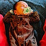 Avery is registered to the contest to win money with this photo: baby, infant, pacifier, sleeping, onesie, brown_clothing, blanket, blue_blanket, red_cushion, cozy, cute, child, indoors, resting, newborn, soft_texture, patterned_clothing, peaceful, portrait, relaxation