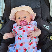 Claire participe au concours pour gagner de l'argent avec cette photo : baby, child, stroller, pacifier, hat, pink, blue_eyes, outdoor, clothing, pattern, fruit_pattern, cherries, strawberries, infant, cute, relaxing, seat, sun_hat, comfort, person