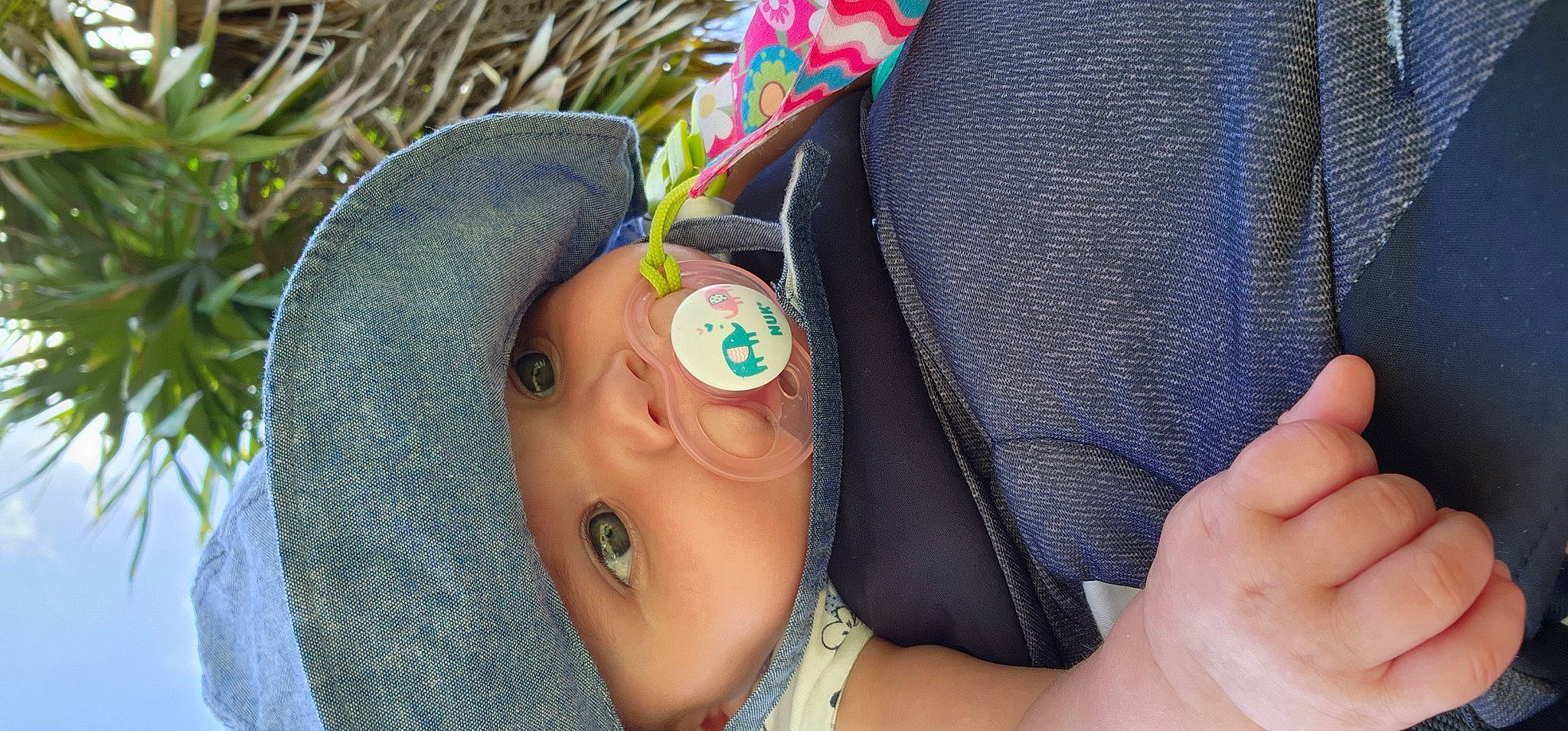 Kynslee is registered to the contest to win money with this photo: azure, baby, cap, eyelash, eyewear, finger, gesture, grass, hand, happy, hat, headgear, headwear, nail, neck, person, personal_protective_equipment, skin, sun_hat, sunglasses