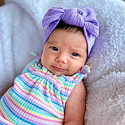 Demi joined the competition — help win amazing prizes! baby, infant, headband, purple_bow, striped_clothing, colorful, blanket, soft_texture, cute, portrait, face, skin, lying_down, indoors, child, apparel, expression, person, newborn, closeup