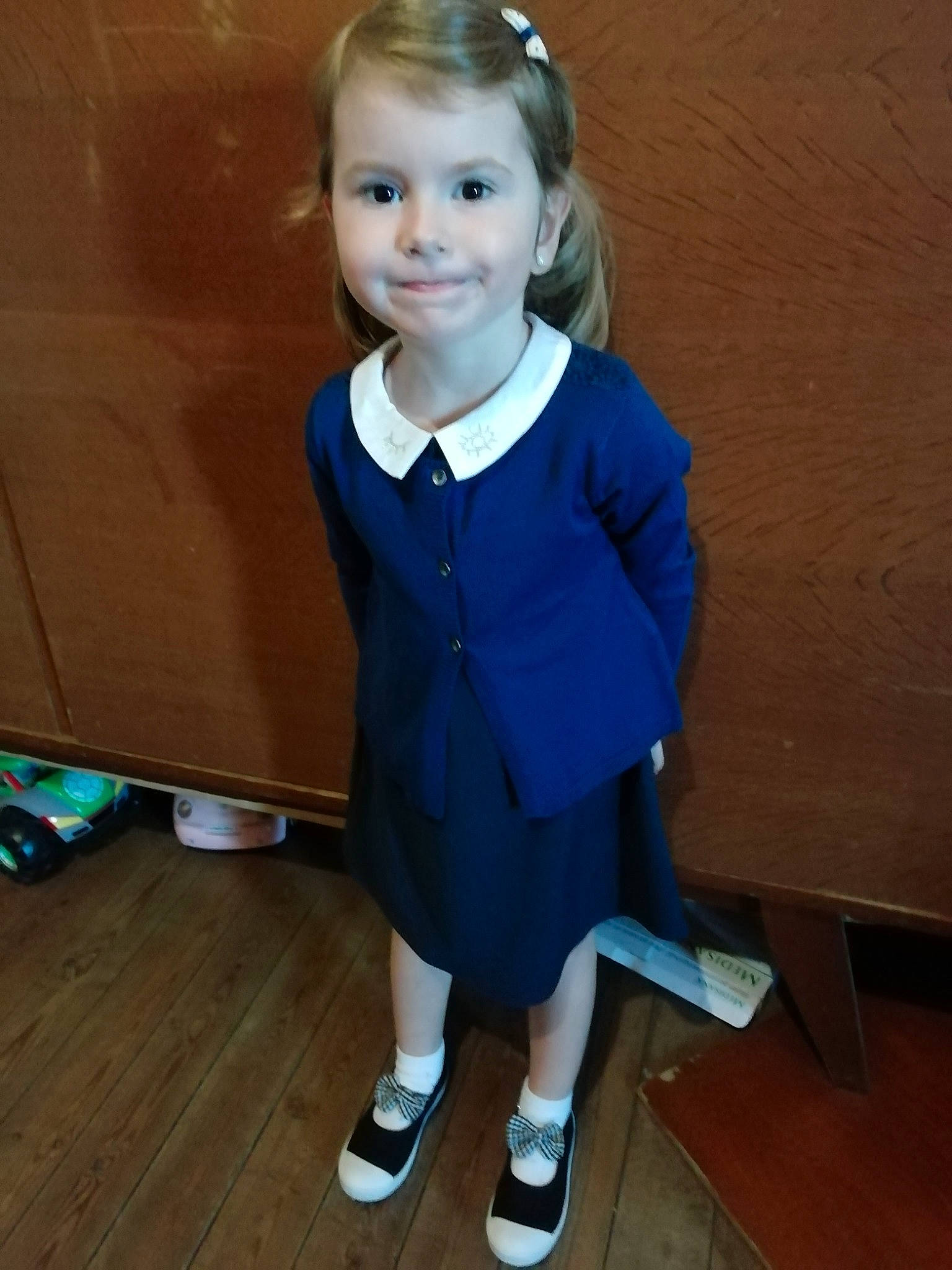 Lucia participe au concours pour gagner de l'argent avec cette photo : child, clothing, outerwear, person, school_uniform, smile, standing, toddler, uniform