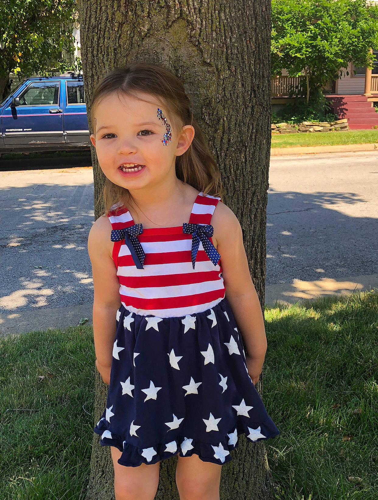 Noelle is registered to the contest to win money with this photo: baby_toddler_clothing, child, day_dress, dress, electric_blue, facial_expression, grass, hair, hairstyle, happy, head, joy, leaf, one_piece_garment, people_in_nature, person, plant, sleeve, summer, toddler