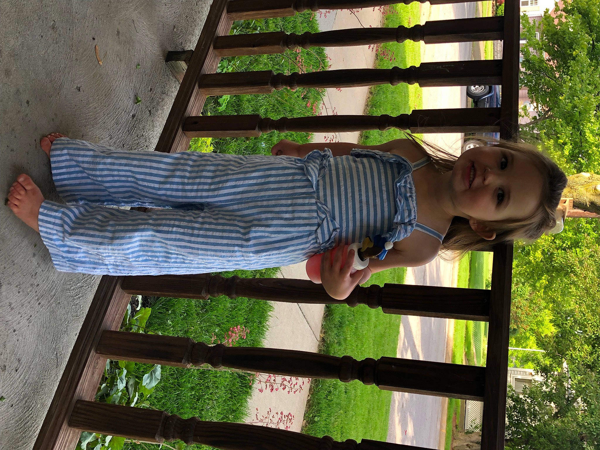 Noelle is registered to the contest to win money with this photo: elbow, foot, grass, happy, human_leg, joy, leisure, pattern, people_in_nature, person, plant, shadow, sleeve, thigh, waist, walking_shoe, white, wood, wrist