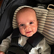 James joined the competition — help win amazing prizes! baby, car_seat, child, infant, straps, smile, face, eyes, clothing, seat, headrest, harness, striped, cute, portrait, indoors, comfort, young_child, person, safety