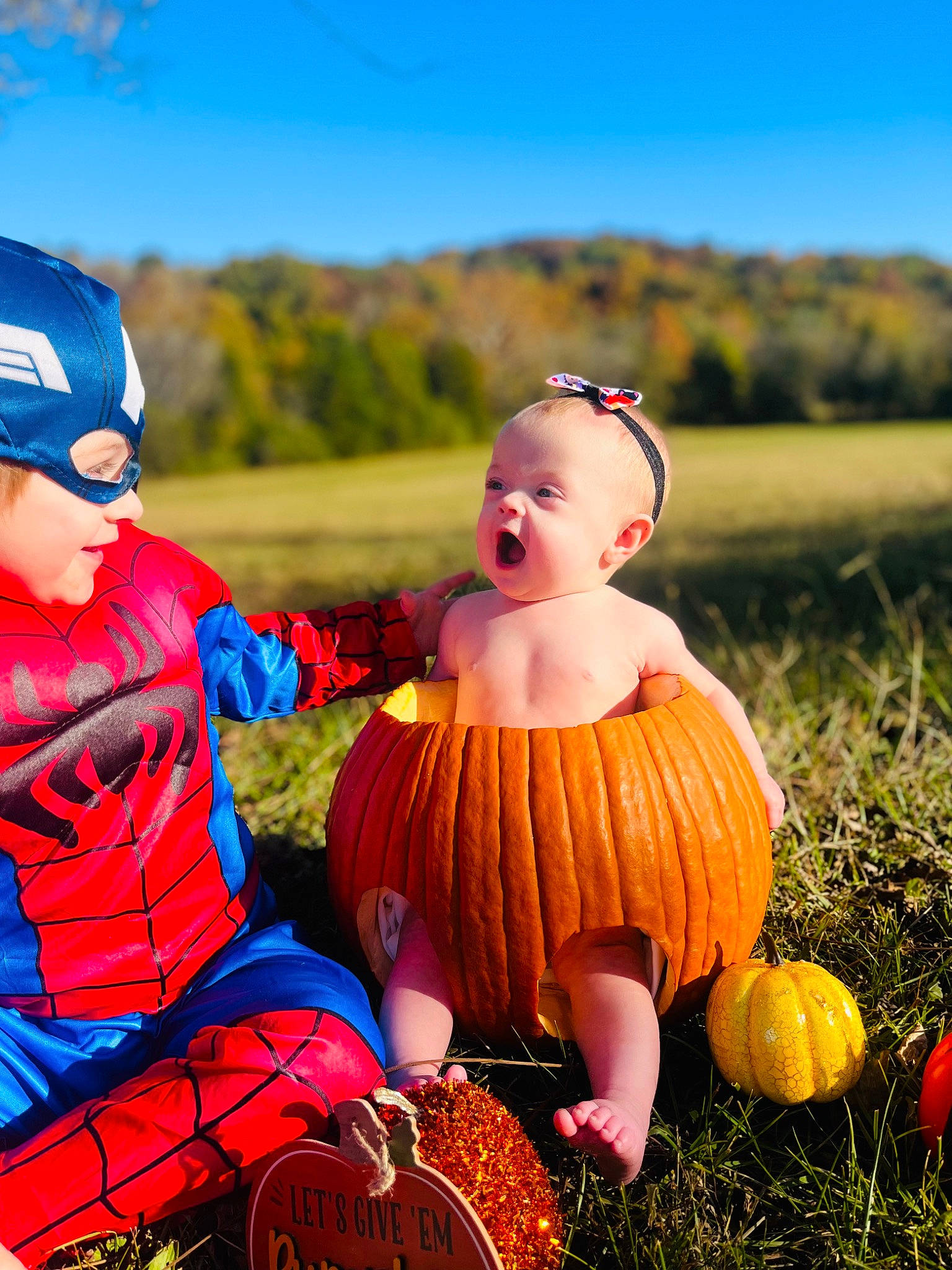 Jackson joined the competition — help win amazing prizes! baby_toddler_clothing, calabaza, cap, child, fun, grass, grassland, happy, headwear, landscape, leisure, people_in_nature, person, plant, prairie, pumpkin, recreation, sky, toddler, tree