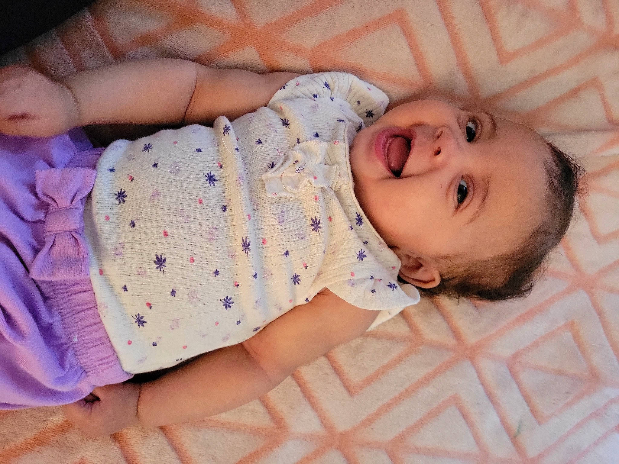 Aria is registered to the contest to win money with this photo: baby, baby_products, baby_toddler_clothing, cheek, child, comfort, eye, finger, flooring, happy, head, headgear, human_body, pattern, person, pink, skin, sleeve, smile, textile