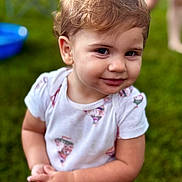 Iris joined the competition — help win amazing prizes! toddler, child, smile, outdoor, grass, person, short_sleeve_shirt, cute, portrait, happy, baby, young_child, curly_hair, playful, innocent, standing, nature, daylight, casual_clothing, skin