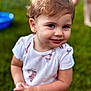 toddler, child, smile, outdoor, grass, person, short_sleeve_shirt, cute, portrait, happy, baby, young_child, curly_hair, playful, innocent, standing, nature, daylight, casual_clothing, skin