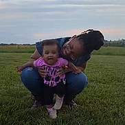 Harmony joined the competition — help win amazing prizes! child, adult, grass, outdoor, field, smiling, happy, person, clothing, pink_shirt, jeans, glasses, sneakers, nature, sky, clouds, holding, playing, toddler, family