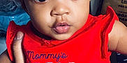Harmony is registered to the contest to win money with this photo: baby, big_eyes, casual, child, clothing, curly_hair, cute, expression, face, hand, holding, indoor, infant, love, person, portrait, red_shirt, sitting, skin, young