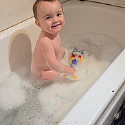 Anthony joined the competition — help win amazing prizes! toddler, bathtub, bath_bubbles, toy, smiling, child, water, foam, indoor, playing, happy, face, skin, hair, bathroom, sitting, person, cute, clean, young
