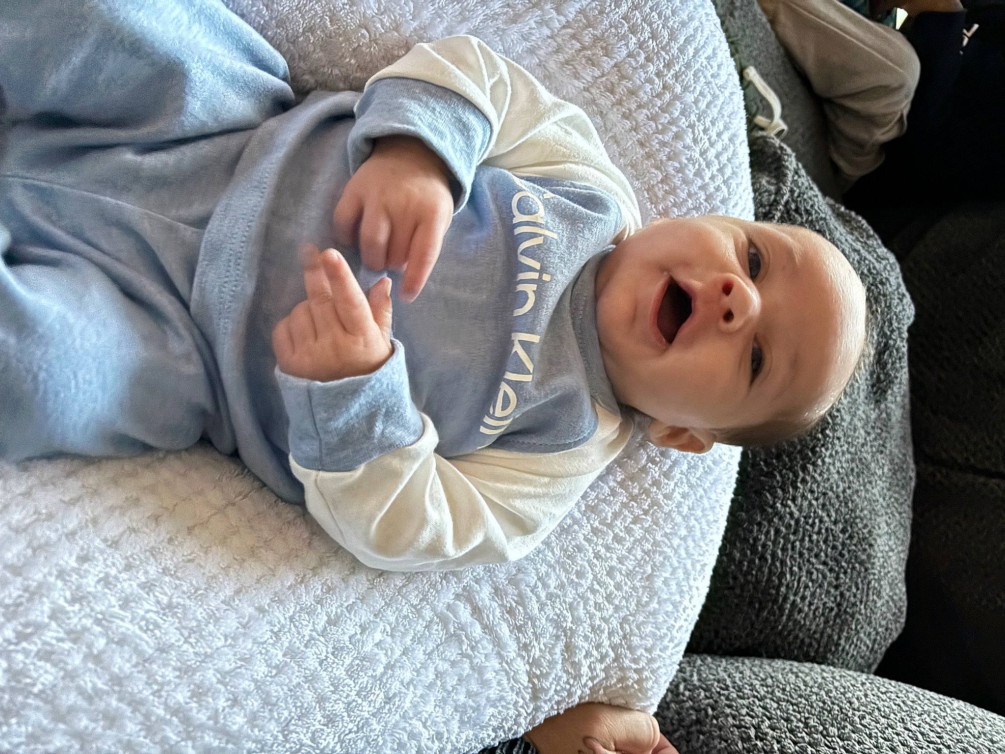 Karsyon Smith is registered to the contest to win money with this photo: baby, baby_toddler_clothing, child, comfort, finger, flooring, fur, gesture, glasses, grass, human_leg, linens, nap, person, room, sitting, sleeve, smile, toddler, tree