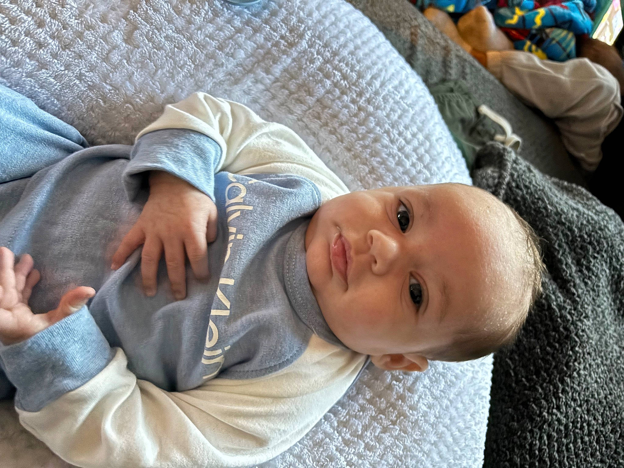 Karsyon Smith is registered to the contest to win money with this photo: baby, baby_toddler_clothing, cheek, child, comfort, elbow, facial_expression, gesture, happy, head, linens, nap, nose, person, sitting, skin, sleeve, smile, toddler, tree