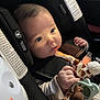 Dominic is registered to the contest to win money with this photo: baby, infant, car_seat, plush_toy, giraffe_toy, pacifier, child, blue_eyes, cute, hands, clothing, seatbelt, safety, car_interior, soft_lighting, portrait, closeup, young_child, cuteness, expression