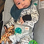 baby, infant, child, onesie, plush_toy, giraffe_toy, rattle, baby_seat, colorful, patterned_clothing, face, eyes, hands, cute, indoors, portrait, smiling, soft_toys, playful, comfort